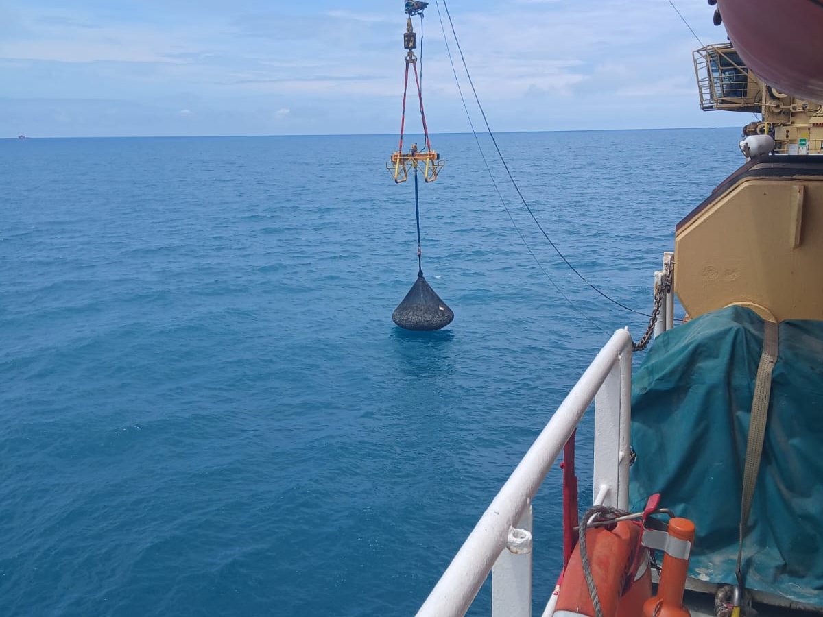 A rock bag lowered from a vessel’s crane
