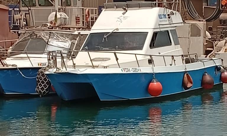 The Reel Time, a catamaran launch, moored in Dakar