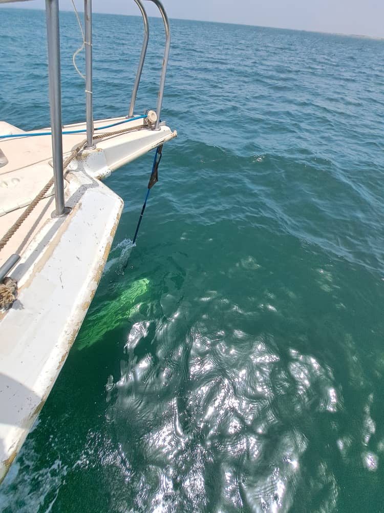 Side-scan towfish rigged at the bow of a partner launch, in shallow clear water off Senegal