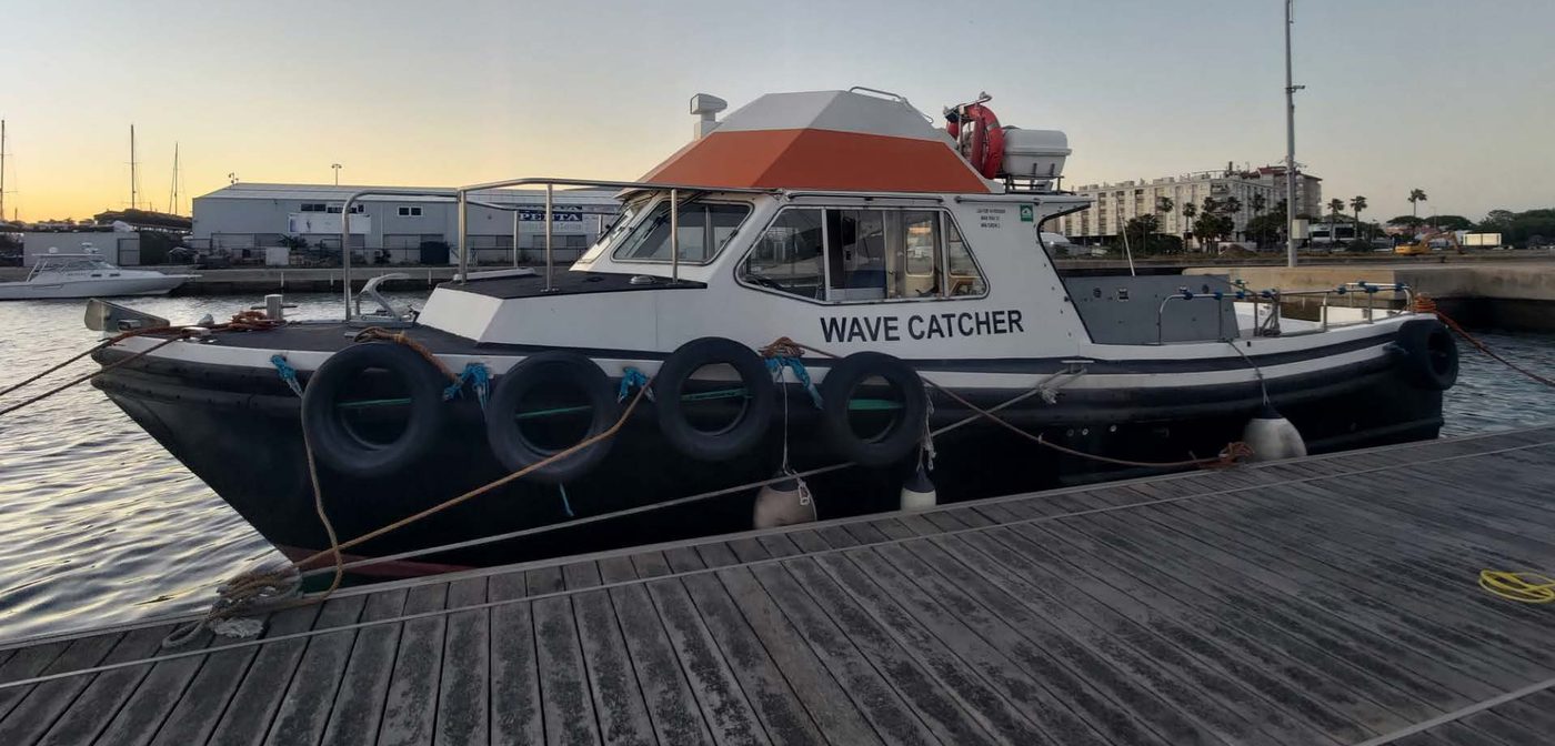 The Wave Catcher alongside a pontoon at dawn